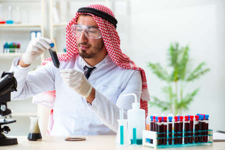 Arab chemist scientist testing quality of oil petrolの写真素材