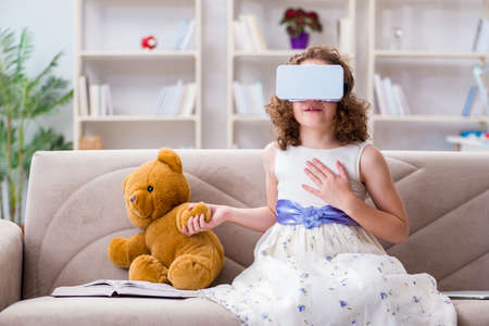Young little girl with VR virtual reality glassesの写真素材