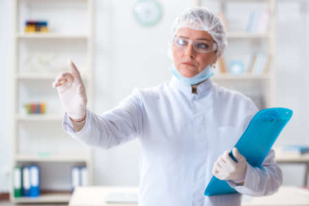 Woman doctor pressing buttons in labの写真素材