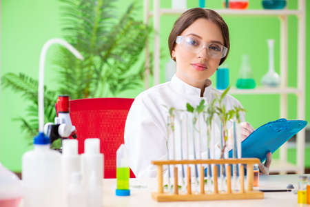 Beautiful female biotechnology scientist chemist working in labの写真素材