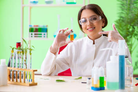 Beautiful female biotechnology scientist chemist working in lab