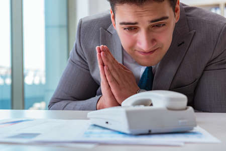 Businessman expecting important call on phoneの写真素材