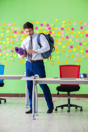 Man in the office with many conflicting priorities preparing goの写真素材