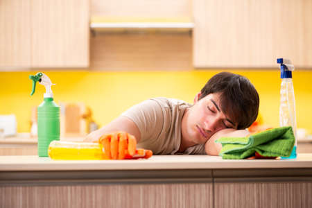 Single man cleaning kitchen at homeの写真素材