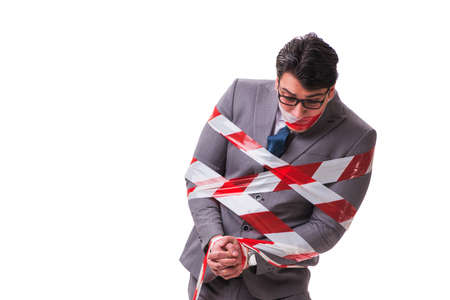 Businessman tied by tape isolated on white