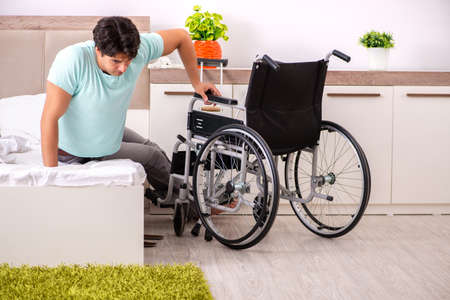 Young handsome disabled man recovering at home
