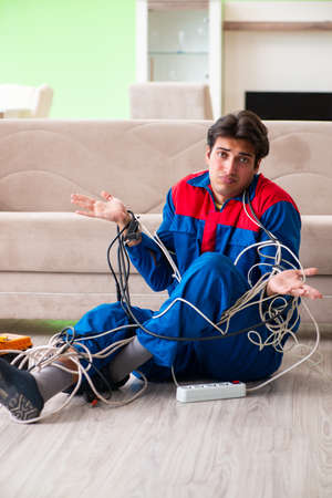Electrician contractor with tangled cablesの写真素材