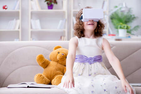 Young little girl with VR virtual reality glasses