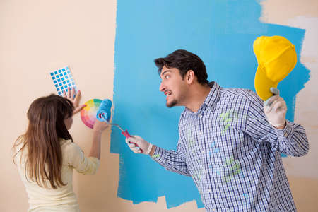 Husband and wife doing renovation at homeの写真素材