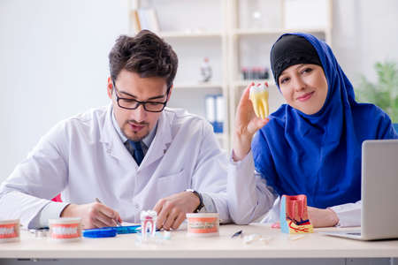 Dentist doctor and assistant working on new tooth implantの写真素材