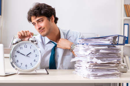Overloaded busy employee with too much work and paperworkの写真素材