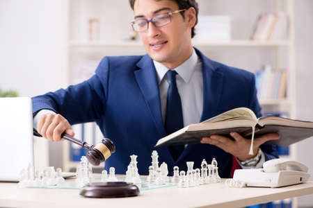 Young lawyer playing chess to train his court strategy and tactiの写真素材