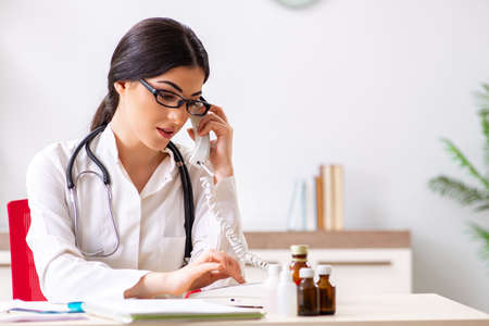 Doctor in telemedicine concept with phoneの写真素材