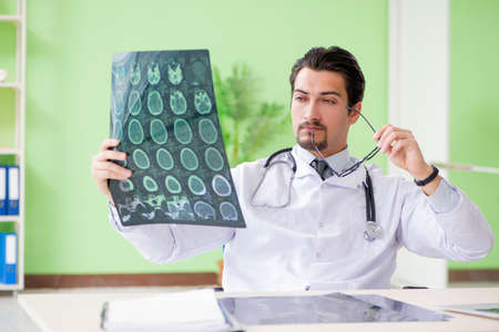 Doctor radiologist looking at x-ray scan in hospital
