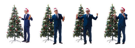 Businessman decorating christmas tree isolated on whiteの写真素材