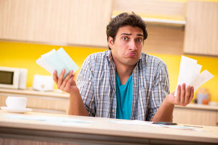 A young husband in budget planning conceptの写真素材