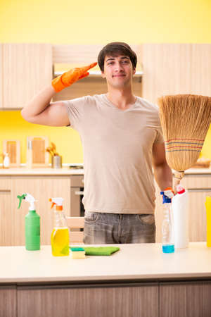 A single man cleaning the kitchen at homeの写真素材