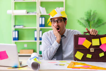 A male engineer working on new project with many conflicting prioritiesの写真素材