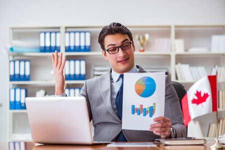 Businessman with Canadian flag in officeの写真素材