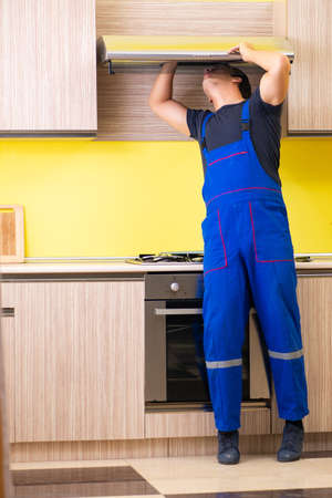 Young service contractor assembling kitchen furnitureの写真素材