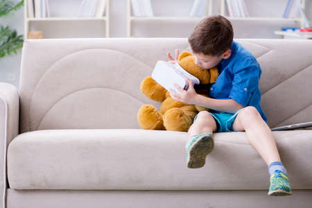 Young little boy with VR virtual reality glassesの写真素材