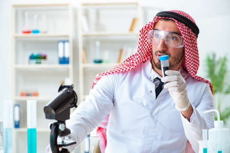 Arab chemist working in the lab officeの写真素材