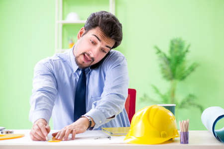 Young male architect working at the projectの写真素材