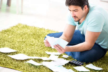 Young man struggling with personal finance and bills