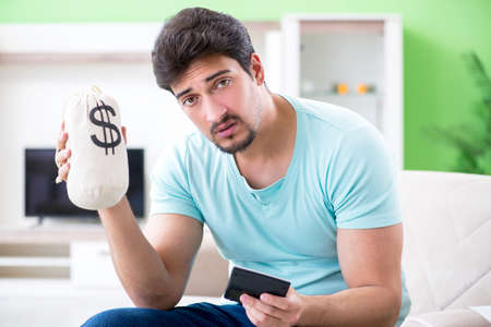 Young man struggling with personal finance and billsの写真素材