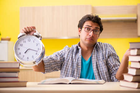 Student preparing for exam sitting at the kitchenの写真素材