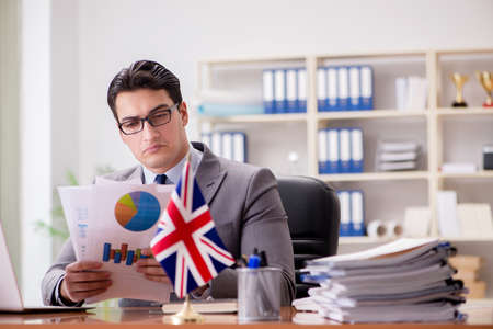 Businessman with British flag in the officeの写真素材