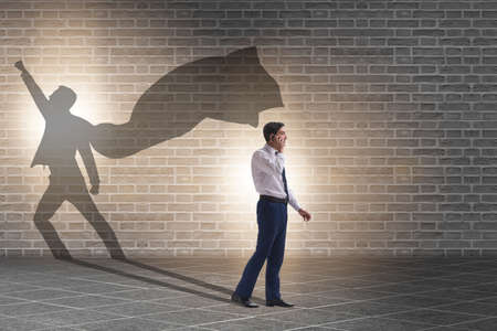 Businessman and his shadow in business concept