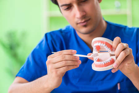 Man dentist working on new teeth implant