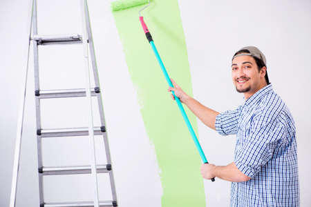 Young painter doing renovation at homeの写真素材