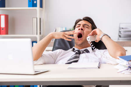 Young call center operator speaking on phoneの写真素材