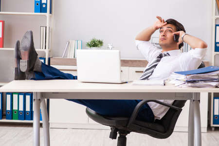 Young handsome businessman working in officeの写真素材