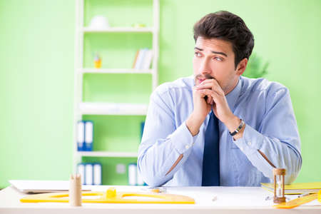 Young male architect working at the projectの写真素材