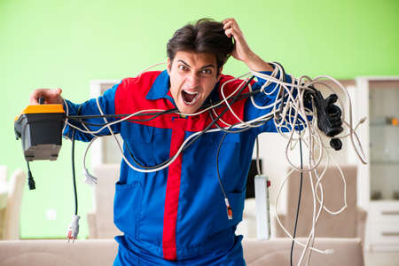Electrician contractor with tangled cablesの写真素材