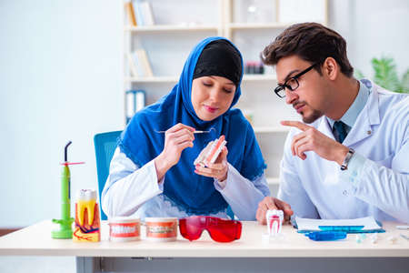 Dentist doctor and assistant working on new tooth implantの写真素材