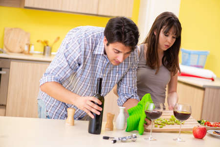 Young couple celebrating wedding anniversary at kitchenの写真素材