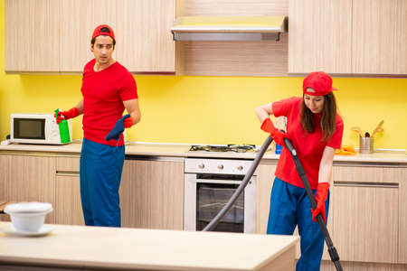 Cleaning professional contractors working at kitchenの写真素材