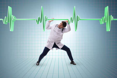 Doctor cardiologist supporting cardiogram heart lineの写真素材