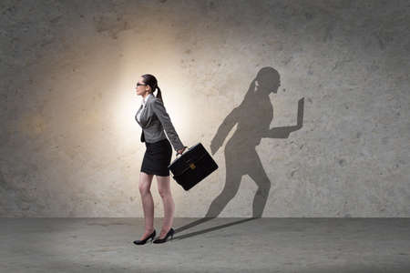 Businesswoman and his shadow in business conceptの写真素材