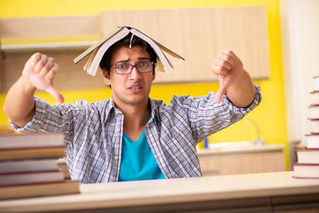 Student preparing for exam sitting at the kitchenの写真素材