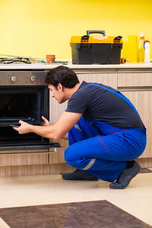 Young service contractor assembling kitchen furnitureの写真素材