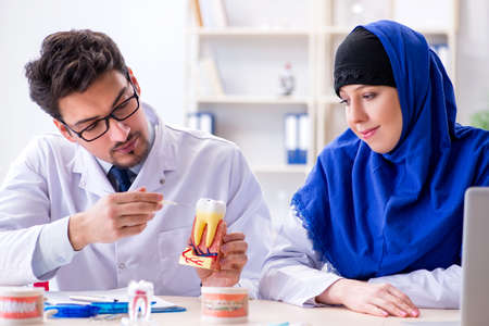 Dentist doctor and assistant working on new tooth implantの写真素材