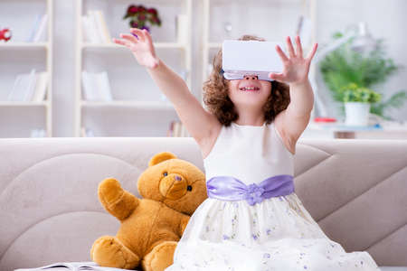 Young little girl with VR virtual reality glasses