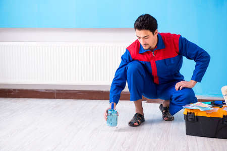 Young man doing home renovationの写真素材