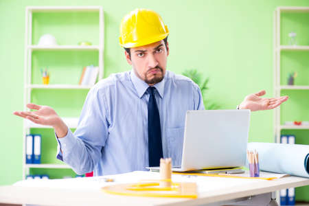 Young male architect working at the project