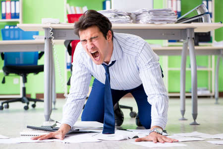 Frustrated businessman stressed from excessive workの写真素材